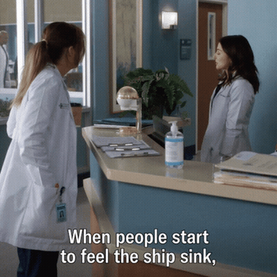 Two Women In Lab Coats Are Standing At A Counter With The Words " When People Start To Feel The Ship Sink " GIF
