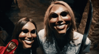 Two Women In Masks And Man In Red Hood Posing GIF