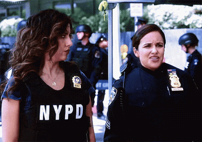 Two Women In NYPD Uniforms Standing Together GIF