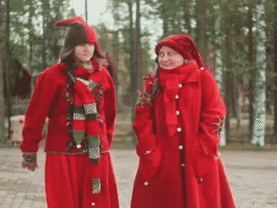 Two Women In Red Clothes And Hats GIF