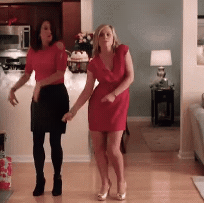 Two Women In Red Dresses Dancing GIF