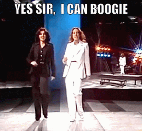 Two Women In Suits Walking On Stage Yes Sir I Can Boogie GIF