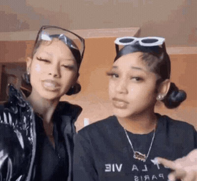 Two Women In Sunglasses And Necklaces GIF