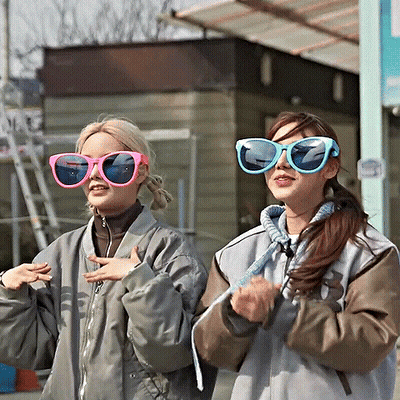 Two Women In Sunglasses Standing Together GIF
