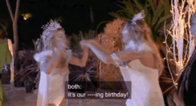 Two Women In White Dresses Are Standing Next To Each Other And Talking . GIF