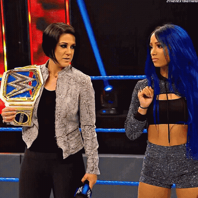 Two Women In Wrestling Ring One Holding World Heavyweight Championship GIF