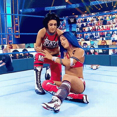 Two Women In Wrestling Ring One Wearing Red Top Saying Bayley GIF