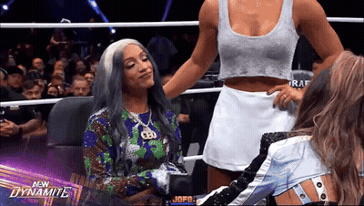 Two Women In Wrestling Ring With Dynamite Logo GIF