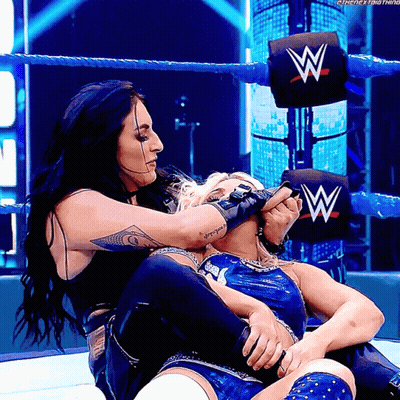 Two Women In Wrestling Ring With W On Wall GIF
