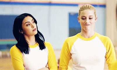 Two Women In Yellow And White Shirts Arms Crossed GIF