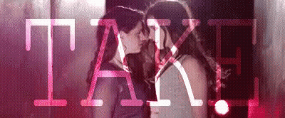 Two Women Kissing In Front Of Pink Take GIF