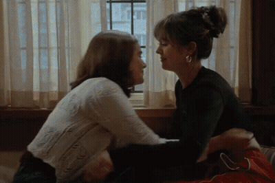 Two Women Kissing In Front Of Window GIF