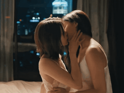Two Women Kissing On Bed At Night GIF