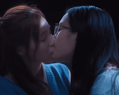 Two Women Kissing One Wearing Glasses GIF