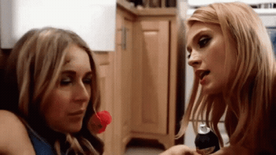 Two Women Kitchen One With Soda Can In Mouth GIF