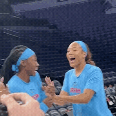 Two Women Laughing In Stadium GIF