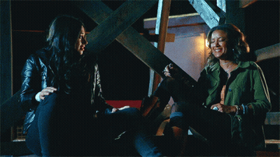 Two Women Laughing On Stairs GIF