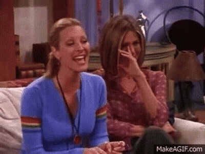 Two Women Laughing, One Covering Mouth GIF