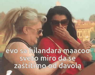 Two Women Laughing One Holding Cell Phone GIF