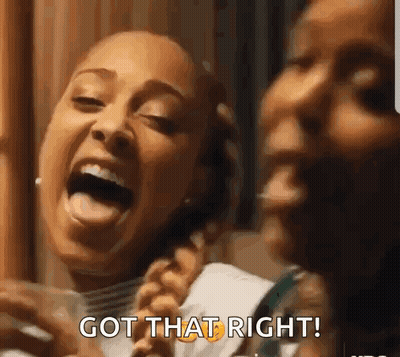 Two Women Laughing One Holding Glass Of Water GIF