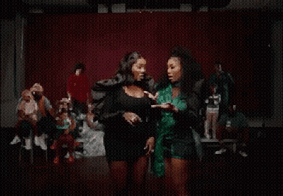 Two Women Laughing, One In Green Top GIF