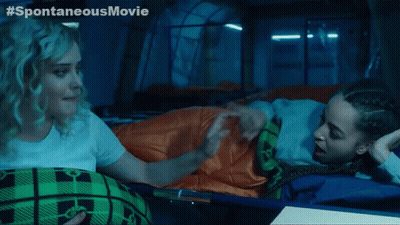 Two Women Laying In A Tent With The Words Spontaneous Movie Written On The Bottom GIF