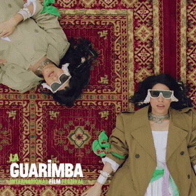 Two Women Laying On Rug Guarimba Film Festival GIF