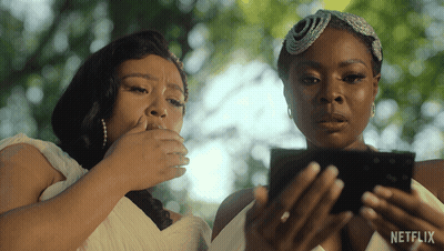 Two Women Looking At A Cell Phone With A Netflix Logo On The Bottom GIF