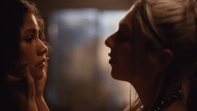 Two Women Looking At Each Other In Dark Room GIF