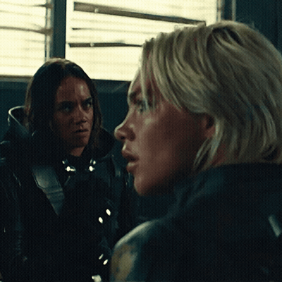 Two Women Looking At Each Other In Dark Room GIF