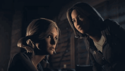 Two Women Looking At Each Other In Dark GIF