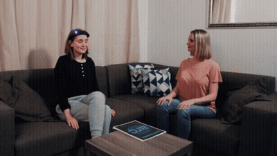 Two Women On Couch With Magazine Saying Arc GIF