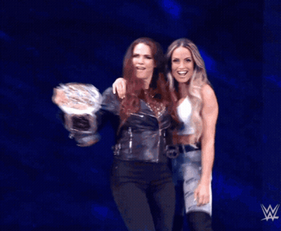 Two Women On Stage With Wrestling Logo GIF