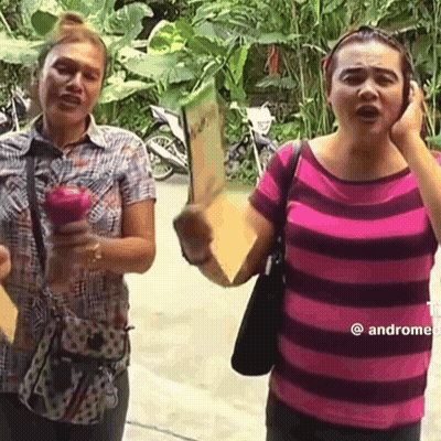 Two Women One Holding Apple One Holding Sign GIF