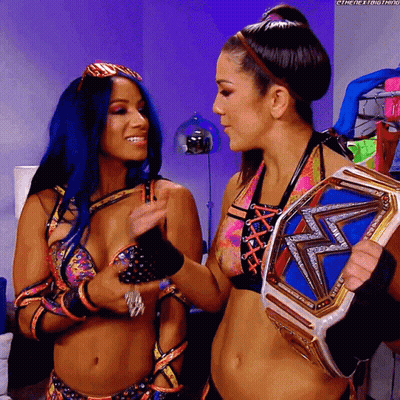 Two Women One Holding Championship Belt GIF