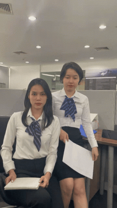 Two Women One Holding Paper GIF