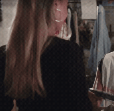 Two Women One With Green Exit Sign Above GIF