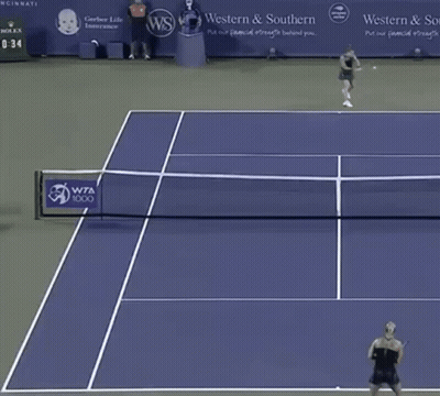 Two Women Playing Tennis With Western Southern Banner GIF