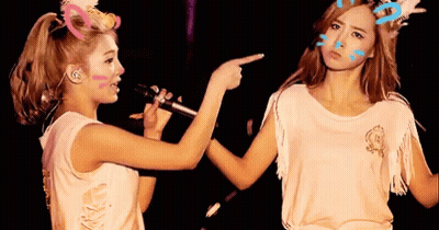 Two Women Pointing At Face GIF