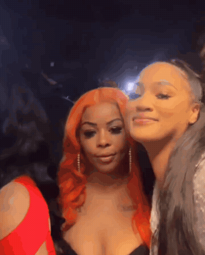 Two Women Posing In Dark Room One Red Hair GIF