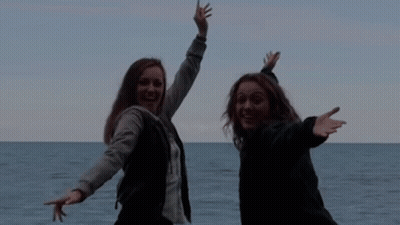 Two Women Posing In Front Of Ocean Saying Ham GIF