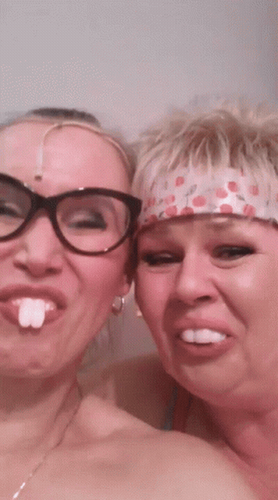Two Women Posing One Wearing Glasses