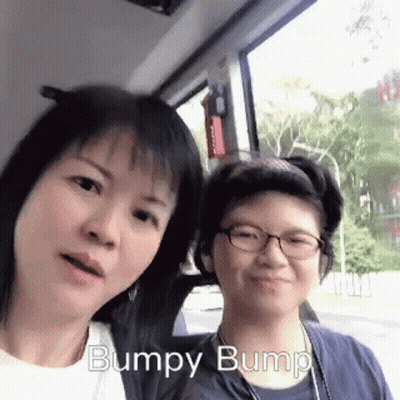 Two Women Posing One With Glasses One In Blue Shirt GIF