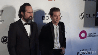 Two Women Posing Red Carpet With Cadillac Marriott GIF
