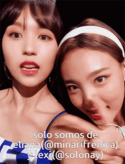 Two Women Posing With Caption Solo Somos De Eliana @Minarifrenica Y Lexi @Solonay GIF