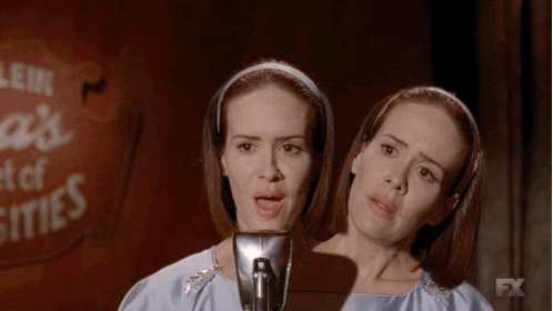 Two Women Singing Into A Microphone With A Fx Logo In The Background GIF