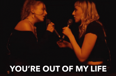 Two Women Singing Into Microphones With The Words " You 'Re Out Of My Life " Above Them GIF