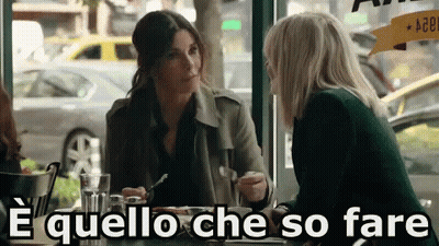 Two Women Sitting At Table Saying E Quello Che So Fare GIF