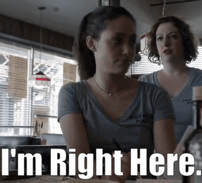 Two Women Sitting At Table Saying I'm Right Here GIF