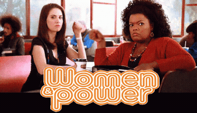 Two Women Sitting At Table Saying Women & Power GIF